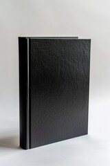 Minimalistic black book standing on white background. Elegant design mockup.
