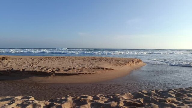 Landscape view of sea sand and coral rocks on a sunny summer day in the afternoon. Molang Beach, Tulungagung, Indonesia