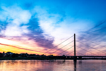 Obraz premium Brücke über Rhein in Düsseldorf bei Sonnenuntergang