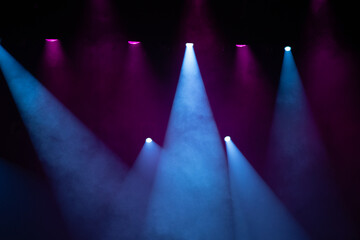 Blue and purple stage lights at a concert.