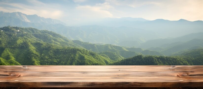 Wooden table with no items on it set against a backdrop of green mountains creates a blurred background Ideal for showcasing your product in a copy space image