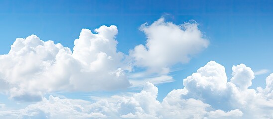 Blue sky with fluffy clouds creates a serene atmosphere in the copy space image