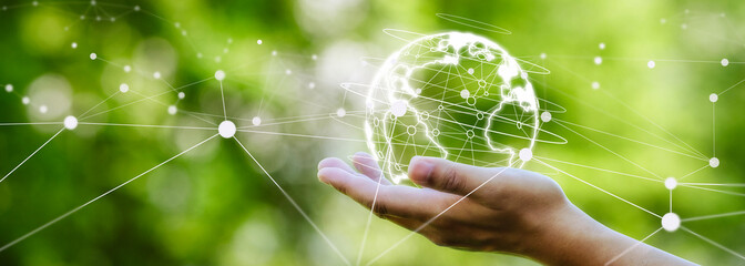 Earth in hand with network lines on green background. Green business concept. and green technology