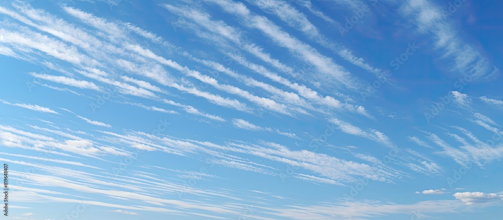Poster clear blue sky with copy space image showing traces of pollution from chemtrails creating a distinct