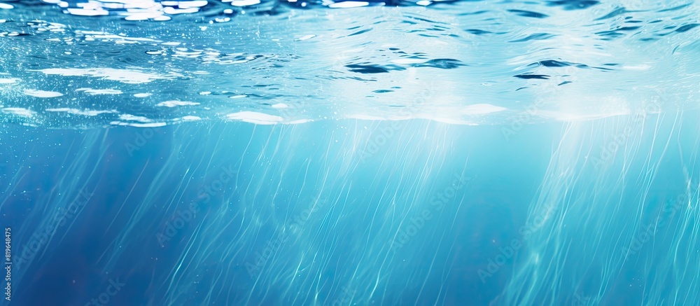 Poster a cool blue colored underwater scene with rippled water creating a blurred swimming pool background 