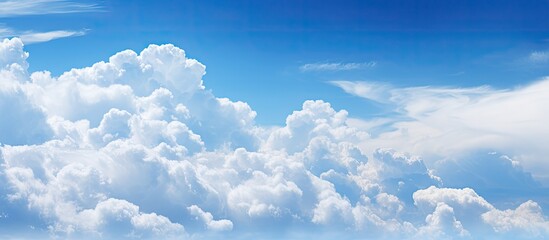 Blue sky with fluffy white clouds copy space image