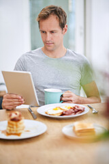Happy, man and breakfast with tablet at table for morning routine with rest, relax and entertainment on holiday at home. Online, male person and tech for watching tv or streaming movies on vacation