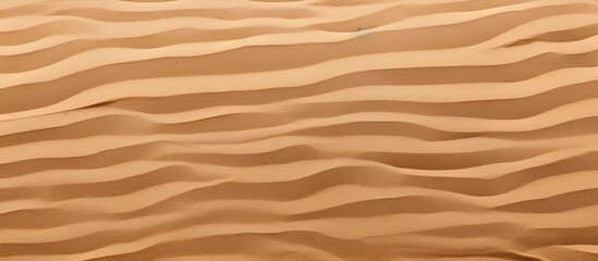 Closeup of a summer beach sand surface with a fine brown sand pattern background for a copy space image