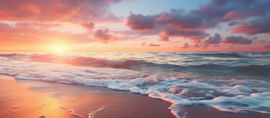 Scenic sunset seascape sandy beach foamy waves vivid sundown hues and clouds over the sea creating a picturesque setting with a copy space image