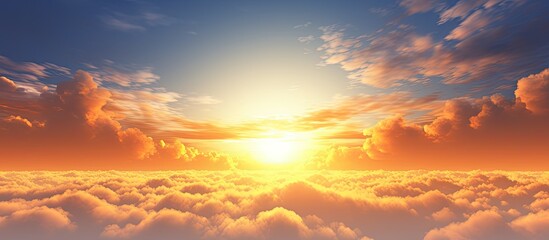 The golden morning sky adorned with clouds of different shapes creates a beautiful sunrise scene with copy space image