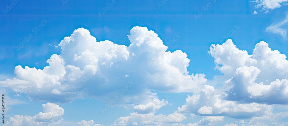 Wall mural Blue sky with clouds in a scenic copy space image