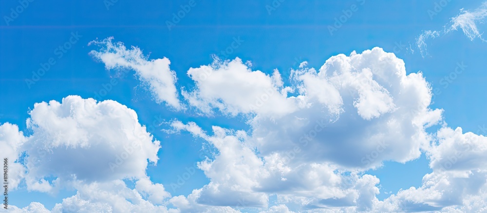 Poster beautiful cirrocumulus clouds against a clear blue sky ideal for use as a background wallpaper digit