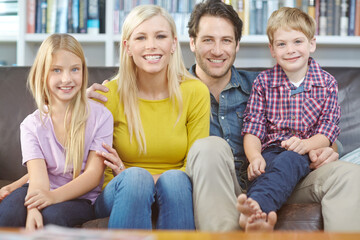 Fototapeta premium Family, children and relax on couch in portrait with love, excited and happy for holiday, weekend or vacation at home. Parents or mother and father with kids together on sofa in living room or lounge