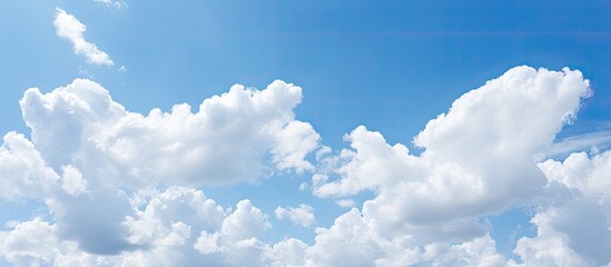 Partly cloudy sky with a few white clouds adds depth and interest to the scene suitable for a copy space image