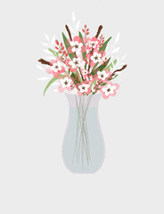 A composition of peony flowers in a glass cup stands on the surface of the table