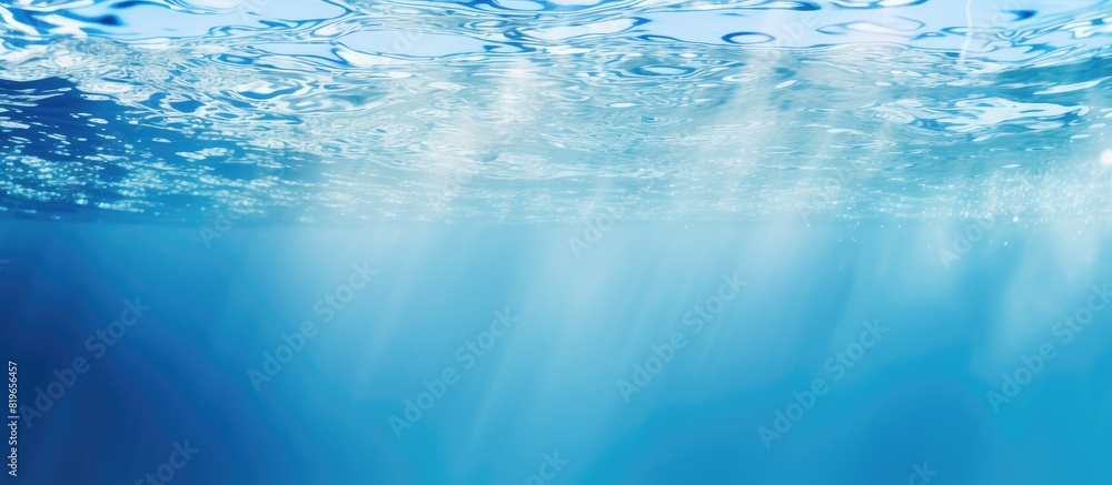 Poster a cool blue colored underwater scene with rippled water creating a blurred swimming pool background 