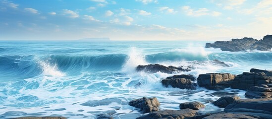 Obraz premium Scenic nature view of tranquil blue waves crashing on rocks offering a serene backdrop perfect for relaxation with a picturesque copy space image