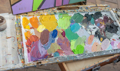 A vibrant artist's palette with an array of oil and acrylic paints, showcasing the creative process...