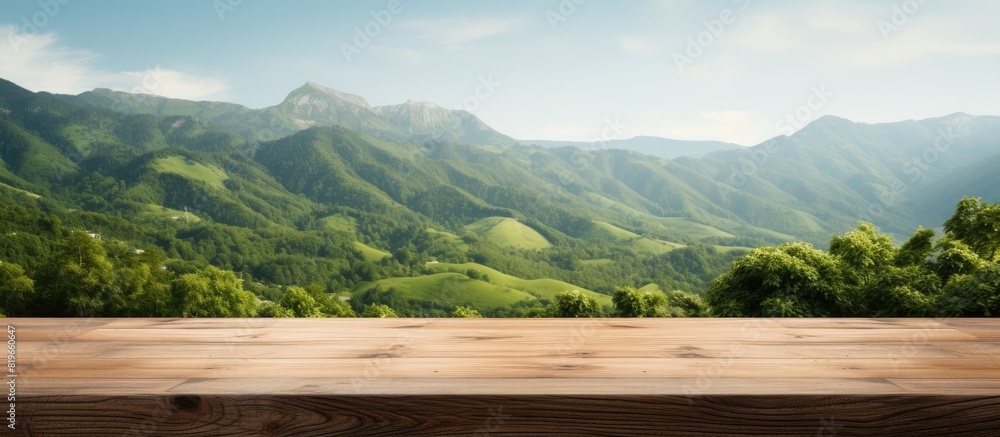 Poster wooden table with no items on it set against a backdrop of green mountains creates a blurred backgro