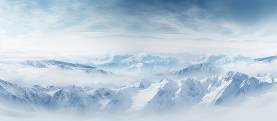 Obraz premium Aerial photograph showcasing stunning mountain landscapes with a vast expanse of snow covered peaks and valleys suitable for use as a copy space image