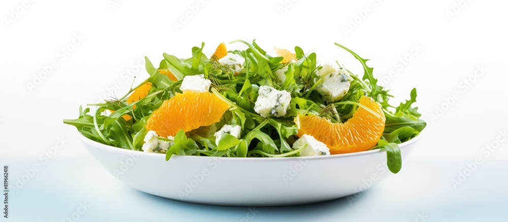 Poster salad with oranges feta cheese and arugula displayed on a white backdrop with copy space image