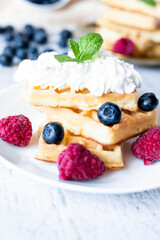 
Belgian Waffles with cream and fruit. on a wooden background. dessert
