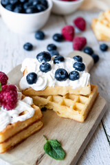 
Belgian Waffles with cream and fruit. on a wooden background. dessert