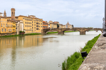 Florence, Italy - April 10, 2024: View of the Santa Trinita Bridge in Florence with tourists crowding its surroundings in Florence, Italy