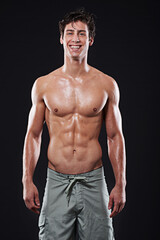 Happy man, fitness and portrait in studio with body, exercise and training on dark background. Pride, professional athlete and Irish male swimmer with abs for health, wellness and workout by backdrop