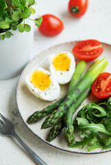 Fresh Spring Salad With Boiled Eggs, Asparagus, and Tomatoes on a Bright Day