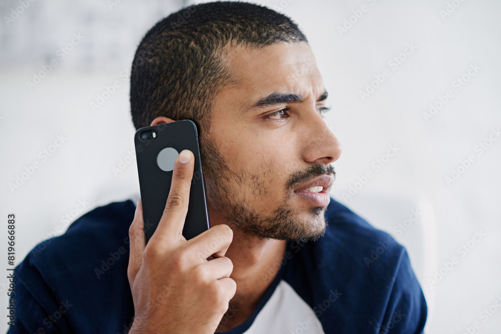 Poster Face, phone call and thinking with designer man in creative workplace for communication or networking. Negotiation, planning or problem solving with serious employee in office for mobile conversation