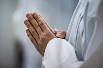 Hands of a priest during a mass in church. Hands of a priest consecrating a host as the body of Christ to distribute it to the communicants in the church