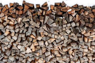Wood pile frontal view with snow on top