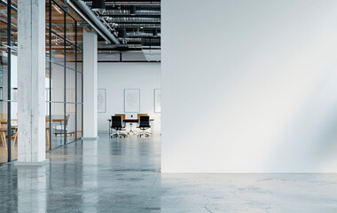 An empty modern office interior with a large white mockup wall, concrete and glass elements,...