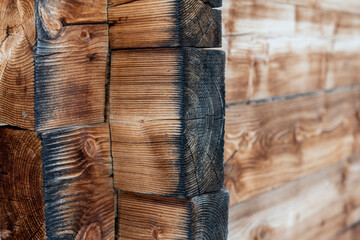Closeup side view of wooden mountain cabin edge as spruce wood texture