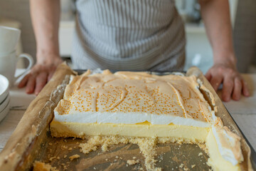 Homemade cheesecake with meringue and golden drops. Traditional polish tear cake