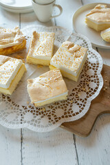 Cheesecake with meringue topping and golden drops. Traditional tear cake served sliced on a cake platter