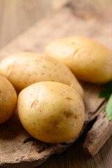 Raw potatoes on wooden background, Food ingredient
