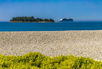 A huge tourist ship enters the port of Rovinj, sailing on the Adriatic Sea on a cruiser