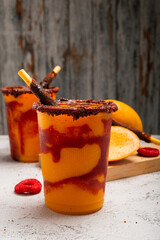 Mangonada, typical mexican mango smoothie with chamoy sauce and lime juice.
