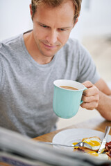 Breakfast, man and newspaper in morning for news, articles and reports before work. Male person, coffee and tabloid at table for updates, current affairs and information at home while eating