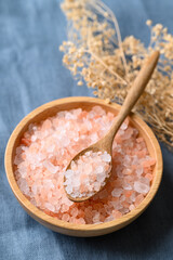 Organic Himalayan pink salt in bowl with spoon, Healthy food ingredient