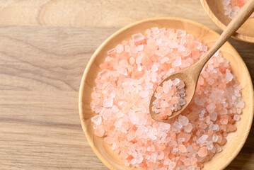 Organic Himalayan pink salt in wooden plate with spoon, Healthy food ingredient, Top view