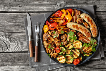 grilled white sausages with veggies and mushrooms