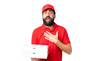 Pizza delivery man with work uniform picking up pizza boxes over isolated chroma key background...