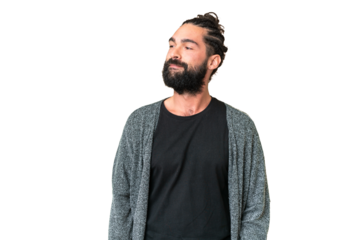 Young man with beard over isolated chroma key background having doubts while looking side