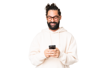 Young man with beard over isolated chroma key background sending a message with the mobile
