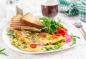 Healthy breakfast. Omelette with cheese, tomatoes   and green herbs. Omelette, salad and toast. Keto, ketogenic lunch.