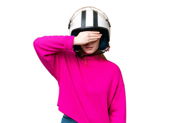 Young pretty woman with a motorcycle helmet over isolated chroma key background covering eyes by hands. Do not want to see something