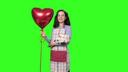 Female florist holding white carnations and red air balloon on the chroma key